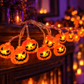 Pumpkin string lights glowing on a mantel